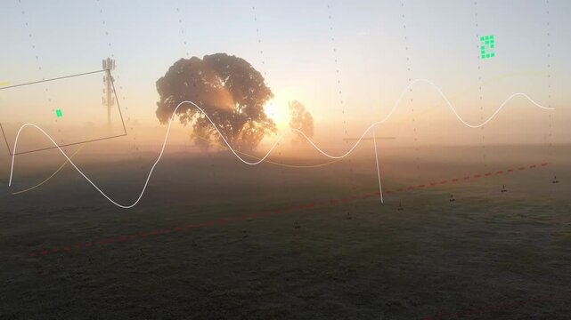 Drone camera shifting view over misty field, sunrise brightening tree, HUD aligning with mast