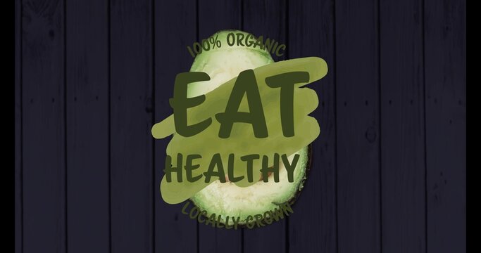 Showing halved avocado centered on dark wood planks, brush EAT HEALTHY 100% ORGANIC LOCALLY GROWN