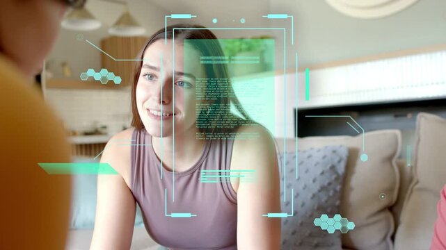 Main woman leaning forward locking gaze on sofa causing teal AR overlay while explaining tech idea