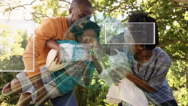 Parents holding children reaching for ball under tree, play causing HUD technology overlay