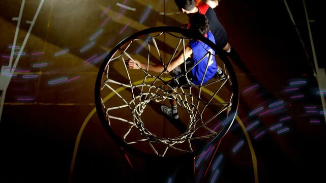 Red player driving from right and attacking basketball rim while blue #2 contesting, seeking score