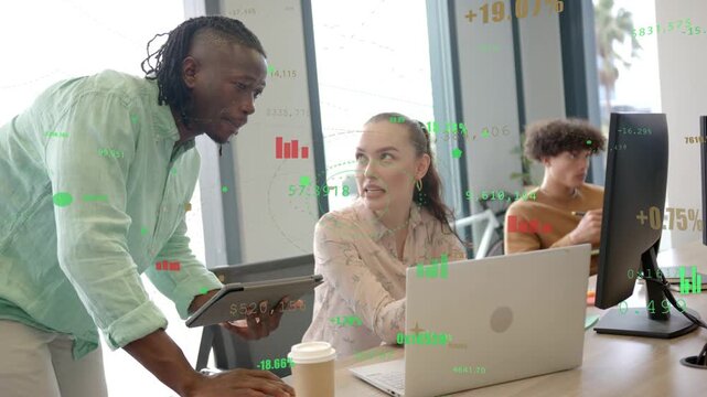 Woman at laptop watching man leaning pointing tablet, clarifying finance charts overlaying, smiling