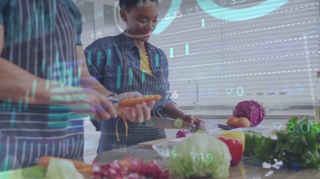 Couple cooking in home kitchen, peeling with peeler and slicing on board, cyan charts showing