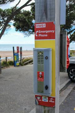 Hot Water Beach, New Zealand - Mar 7, 2026: An Emergency Response Beacon (ERB) with a specialized emergency telephone installed at a beach. For Editorial Use.