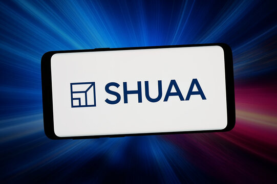 Stuttgart, Germany - 04-13-2026: In this photo illustration, the logo of Emirati investment company SHUAA Capital psc is displayed on a smartphone in front of abstract background on computer screen.