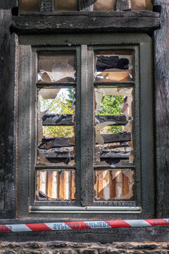 Close up of the window of the ruins of a house burned in a fire accident or arson