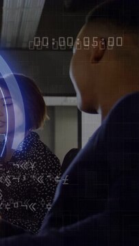 Vertical video: Woman glancing speaking to man listening in business, blue HUD timecode over face