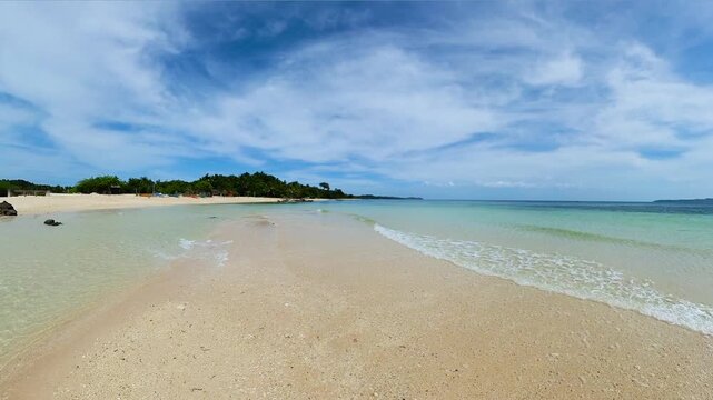 Ocean waves crashing each other over the sands. Santa Fe, Tablas Island. Romblon, Philippines.