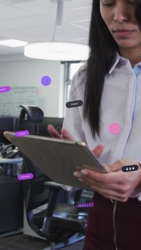 Vertical video: Woman tapping tablet causing office overlays while checking DM camera pulling back