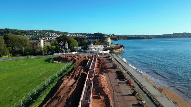 Paignton, Devon, England: DRONE VIEWS: A sea defence wall under construction on Paignton Green. The project will be completed in 2027 to protect seafront properties from global rising sea levels.