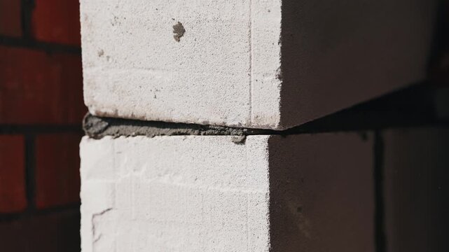 Stacking aerated concrete blocks with mortar joint close up
