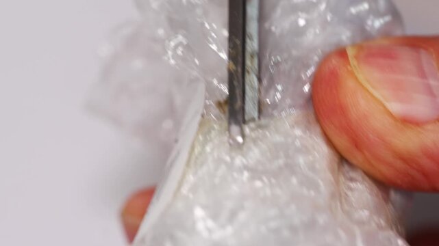 Unpacking a package with scissors in four simple steps