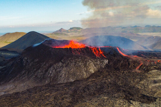 Aerial view of Icelandic volcanic eruption with glowing lava rivers in standard 3x2 landscape format.
