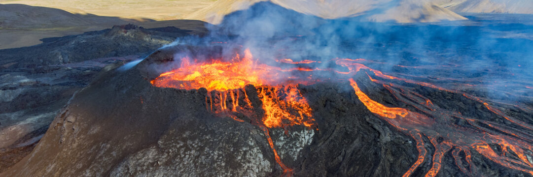 Ultra-wide 3x1 panoramic close aerial view of Icelandic volcanic eruption with bright lava streams on dark rock.