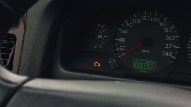 Dashboard lights glow. Closeup of dashboard featuring bright glowing instrument panels. Nighttime vehicle dashboard illuminated with colorful signals and indicators for visibility