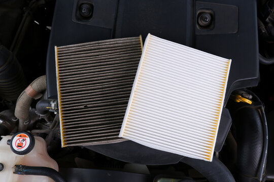 New vs. Dirty Engine Air Filter, A side-by-side comparison of a clean white car engine air filter and a dirty, clogged one