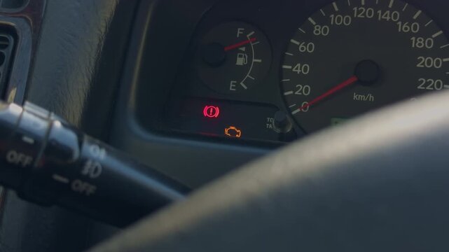 Closeup steering wheel warning lights glowing, brake lamp and engine icon create tense mood, night commute pause with reflective instrument glass, cinematic slowmotion feel