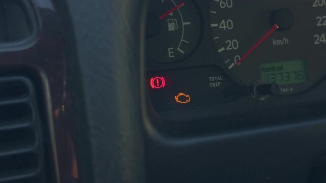 Pretrip inspection with warning symbols. Amber engine and brake indicators in clear slow motion. Highdefinition footage showing detailed warning lights during vehicle safety inspection
