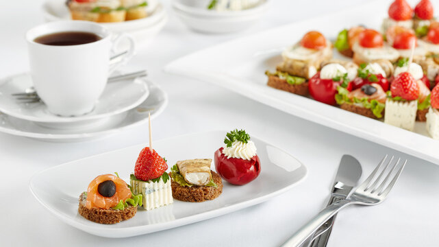 Assortment of gourmet appetizers and canapes on white table