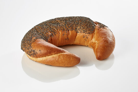 Poppy seed crescent roll on white background