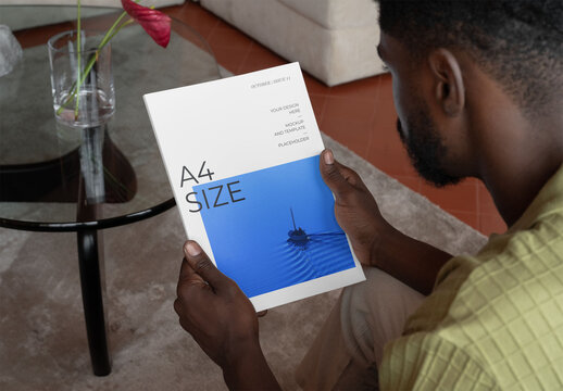 Mockup Of Man Holding Customizable A4 Magazine