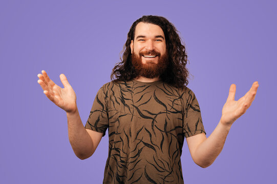 Bearded Caucasian Man Smiling, Open Arms. Studio Portrait With Purple Background, Patterned Shirt, Warm