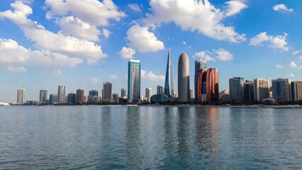 Obraz premium Modern Skyline Reflection on Water Under Bright Blue Sky