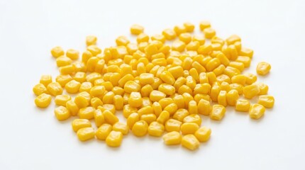 Fototapeta premium A pile of yellow corn kernels on a white background.