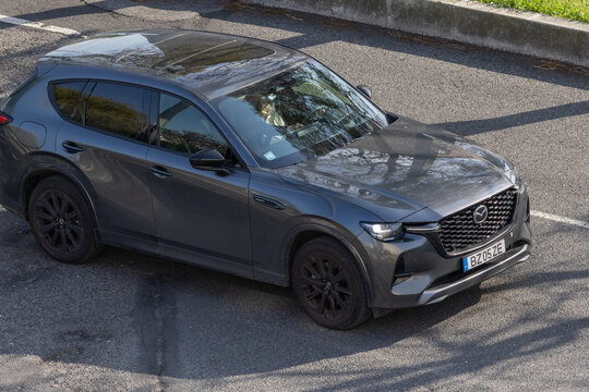 Mazda CX-50 subcompact crossover SUV driving on a sunny day
