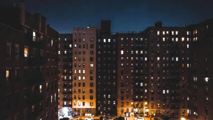 Obraz premium Urban Night Scene of Apartment Buildings with Glowing Windows and Stars