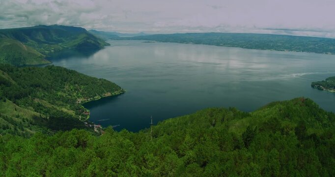 Aerial Drone View of Lake Toba with Green Hills and Calm Water