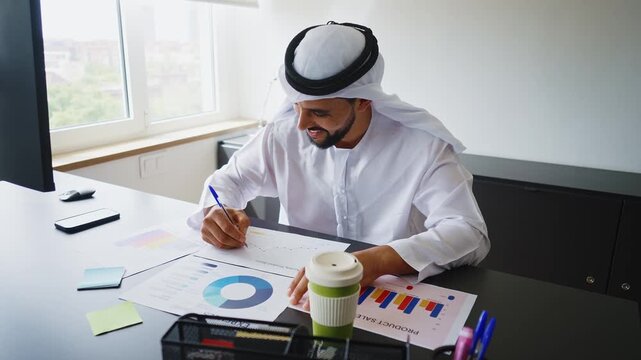 Men with dish dasha working in business office of Dubai. Portraits of successful businessmen in traditional emirates white dress. Concept about middle eastern cultures.