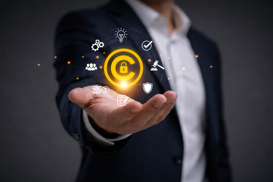 Businessman holding copyright symbol represent intellectual property protection, copyright monitoring, digital rights management, legal compliance and content ownership security.