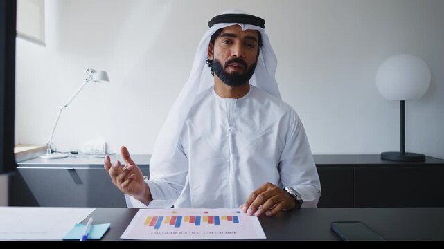 Men with dish dasha working in business office of Dubai. Portraits of successful businessmen in traditional emirates white dress. Concept about middle eastern cultures.