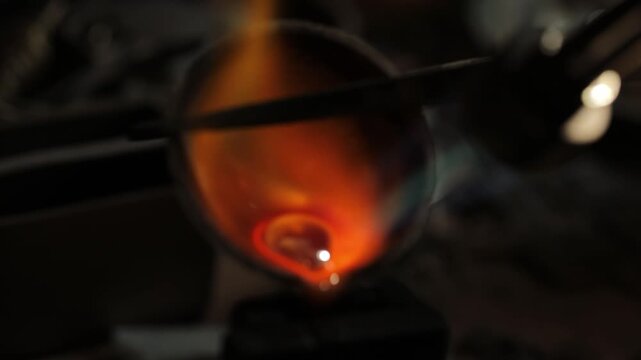 Molten gold glowing in a crucible under intense heat, captured in a close-up with vibrant orange and yellow hues.