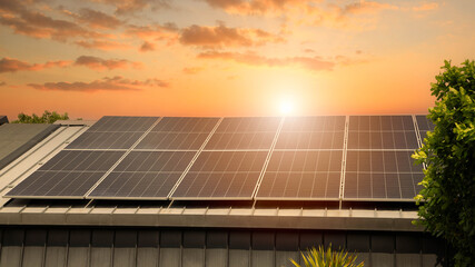 Solar panels on the metal roof of a modern house under a clear blue sky with sunlight.Green energy solution with solar cell panels on house roof against bright sky. © Rangsarit