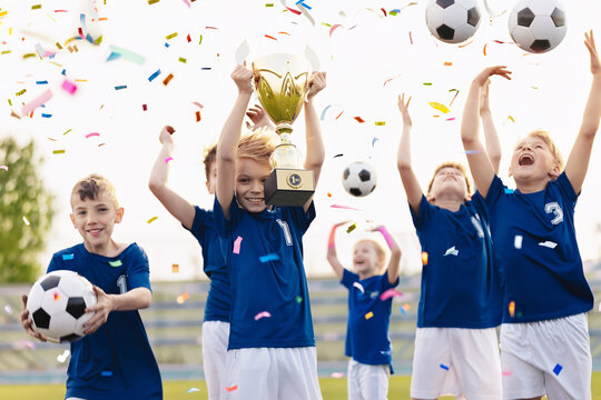 Youth Soccer Team Celebrating Victory. Kids Holding Trophy with Confetti After Football Match Win