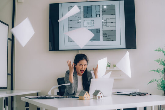 Frustrated Businesswoman Throwing Papers in Office