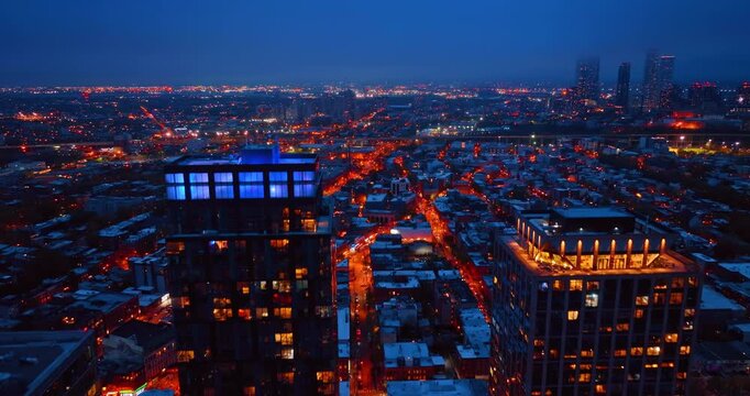 City streets glowing with orange lights. Beautiful illumination of Jersey City, New Jersey, USA at night.