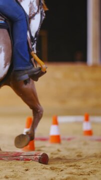 Horse riding around cones at horsemanship competition in slow motion
