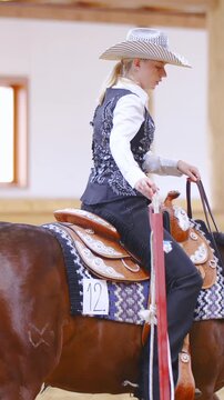 Western horse rider enter through rope door at competition