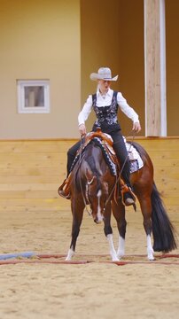Cowgirl turning horse inside the cavaletti square with ease in slow motion