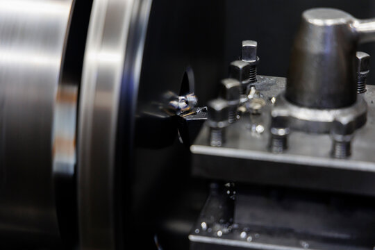 Precision CNC Lathe Machining Process with Metal Shavings and Industrial Turning Tool