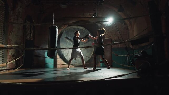 Intense cardio workout on box ring, female athlete jumping and punching. Professional sport and activity for stay healthy and lose weight, care about body condition, developing endurance, combat sport