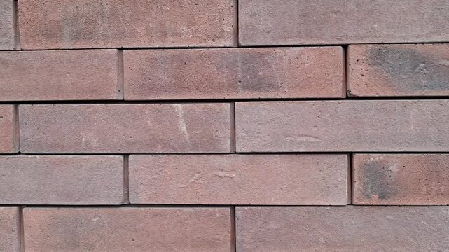 Reddish-brown brick wall, clean dark joints. For construction backgrounds, urban designs, loft interiors. Rustic yet modern brickwork texture, subtle color variations. Weathered surface, precise lines