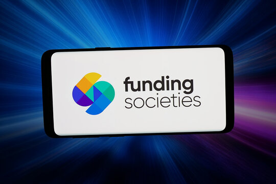Stuttgart, Germany - 04-13-2026: In this photo illustration, the logo of financing company Funding Societies Pte. Ltd. is displayed on a smartphone in front of abstract background on computer screen.