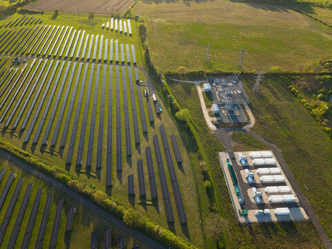 Aerial view of Tiln Photovoltaic Solar Farm and Battery Energy Storage System with rows of solar panels and battery units in Retford, England, United Kingdom.