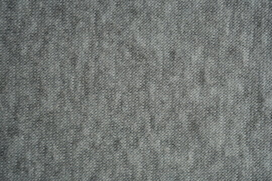 grey fleece fabric texture, macro texture fleece gray fabric photo above as background macro texture of grey fleece fabric. Close-up of soft synthetic textile surface with fine fibers and smooth fluf
