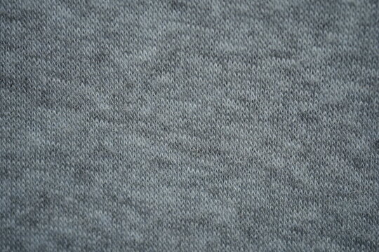 grey fleece fabric texture, macro texture fleece gray fabric photo above as background macro texture of grey fleece fabric. Close-up of soft synthetic textile surface with fine fibers and smooth fluf
