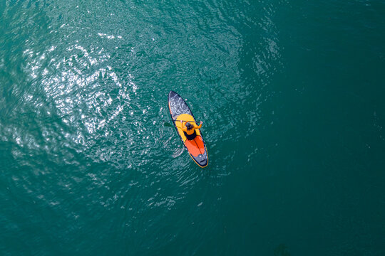 Aerial View of Woman Paddle Boarding on Turquoise Sea Stand Up Paddle Activity